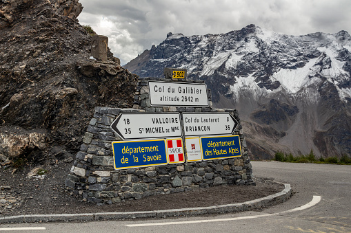 Col du Galibier, France - September 20, 2021: Summit of the Col du Galibier with the famous road signs marking the highest point of the mountain pass