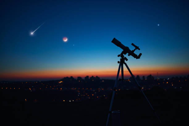 istock Astronomical telescope under a twilight sky ready for stargazing. 1365684522