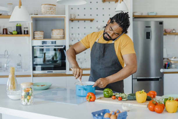 istock African-American man preparing meal in the kitchen 1365684582