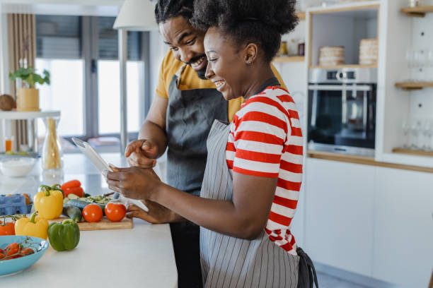 istock Young couple cooking together in the kitchen 1365684673