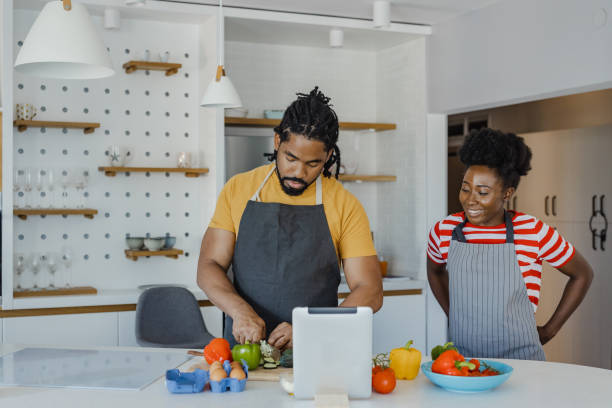 istock Young couple cooking together in the kitchen 1365684707