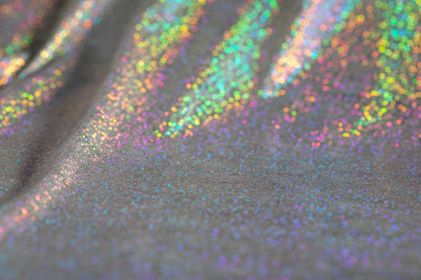 Abstract background of holographic rainbow fabric. Soft focus.