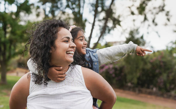 istock Indian mother and daughter having fun at park 1365685872