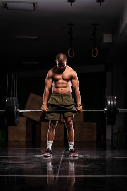 istock Muscular athlete lifting very heavy barbell 1365686231