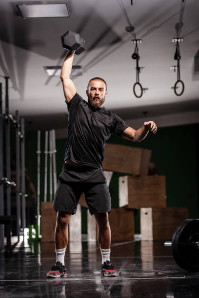 istock Muscular athlete lifting very heavy weights. Man working out indoors. 1365686240
