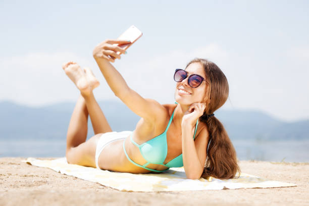 istock girl taking selfie on a beach 1365687338
