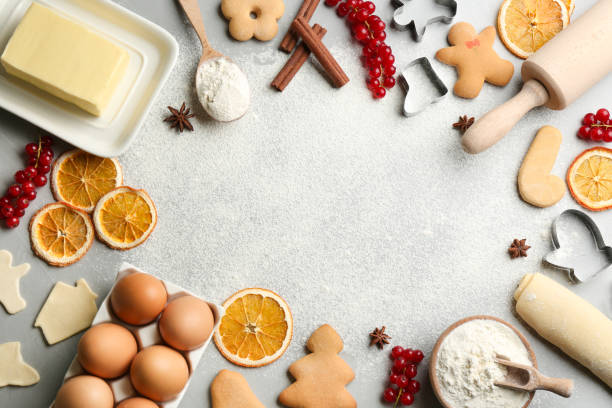 istock Flat lay composition with homemade Christmas cookies and ingredients on grey table, space for text 1365687552