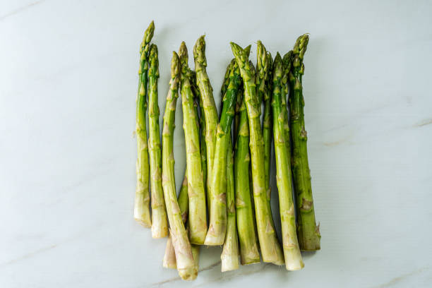 istock Group of raw green asparagus isolated on white background. 1365688951