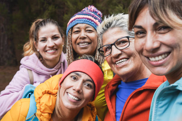 istock Multiracial women having fun taking a selfie during  trekking day - Multi generational people enjoy day in nature 1365689437