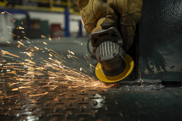 istock Sparks ejected by grinding disk as worker uses angle grinder to smooth welds on truck bed 1365692691
