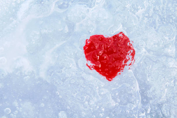istock Red heart on blue ice. Close-up. Background. Texture. 1365692921