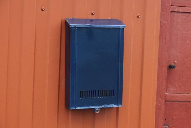 istock one blue iron mail box hanging on a red metal fence 1365693474