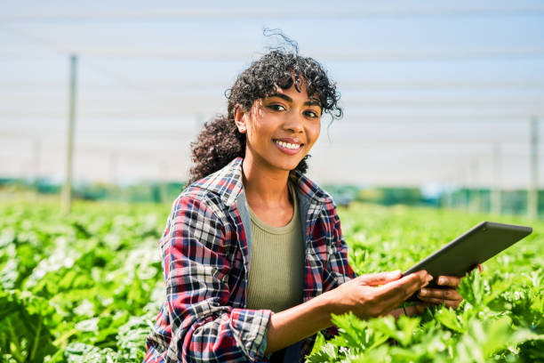 istock Portrait of a young woman using a digital tablet while inspecting crops on a farm 1365693907