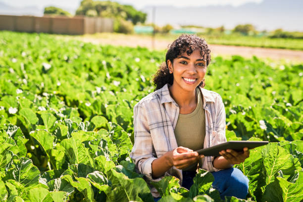 istock Portrait of a young woman using a digital tablet while inspecting crops on a farm 1365693935