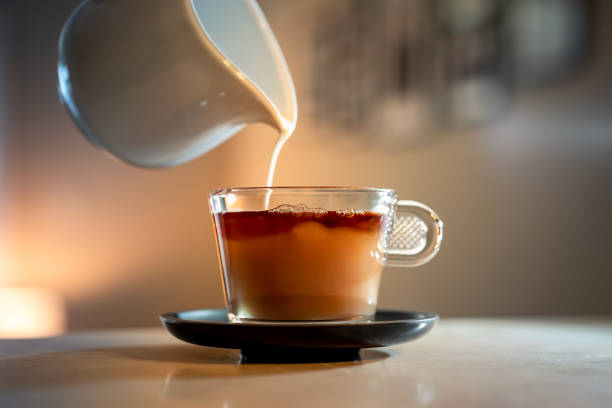 istock Hot breakfast tea with milk in glass cup 1365695080