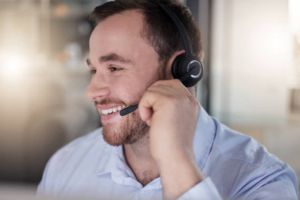 istock Shot of a young call centre agent working in an office at night 1365699420