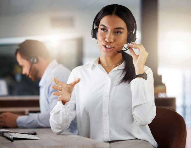 istock Shot of a young call centre agent working in an office at night 1365699519