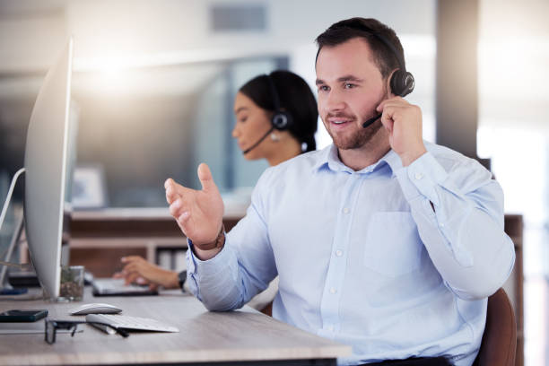 istock Shot of a young call centre agent working in an office at night 1365699521