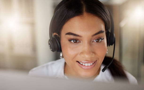 istock High angle shot of a young call centre agent working on a computer in an office at night 1365699563