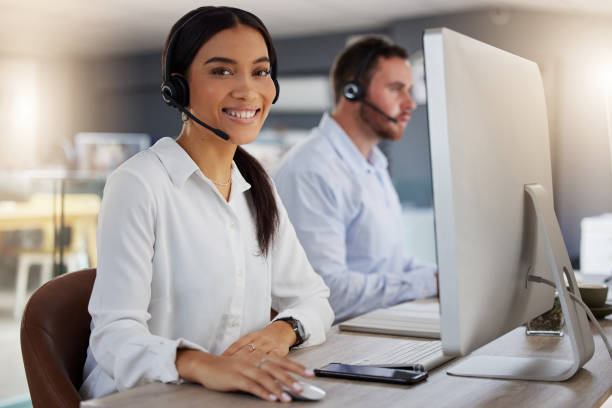istock Portrait of a young call centre agent working on a computer in an office at night 1365699576