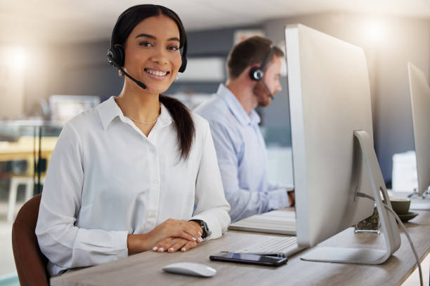 istock Portrait of a young call centre agent working on a computer in an office at night 1365699608