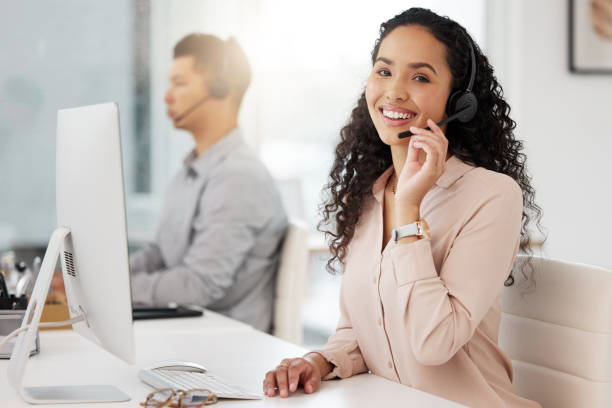 istock Portrait of a young call centre agent working on a computer in an office 1365702861