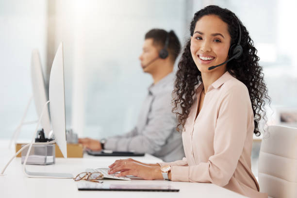 istock Portrait of a young call centre agent working on a computer in an office 1365702865