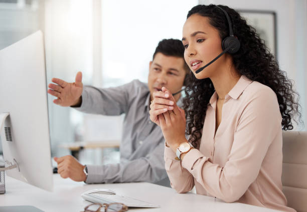 istock Shot of two call centre agents working together on a computer in an office 1365702872