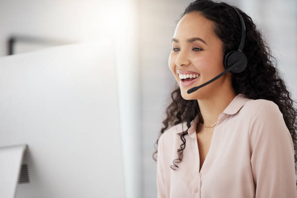 istock Shot of a young call centre agent working on a computer in an office 1365702876