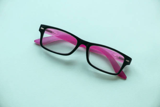 istock A black and pink glasses on a green background. 1365704892