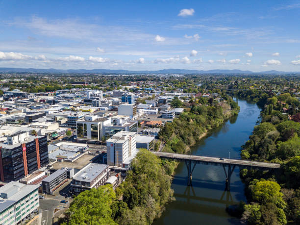 Aerial drone view of Hamilton City (Kirikiriroa) in the Waikato Region of New Zealand, Aotearoa Aerial view looking over the central business district from the Waikato River as it cuts through the city of Hamilton, in Waikato, New Zealand. Claudelands Bridge visible. waikato river stock pictures, royalty-free photos & images
