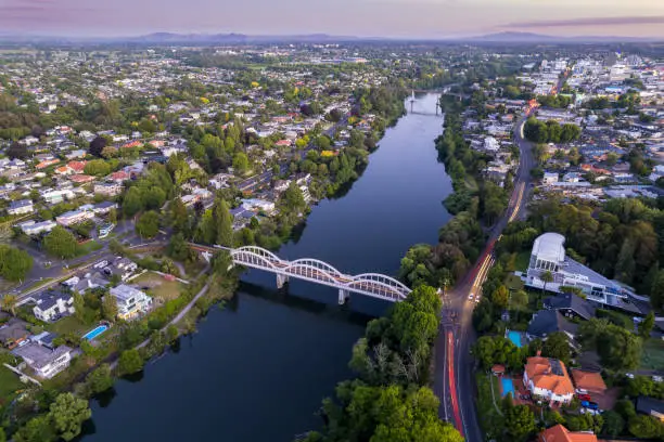 A drone captured view looking towards the central business district (CBD) from the Fairfield Bridge over the Waikato River as it cuts through the city of Hamilton, in Waikato, New Zealand.