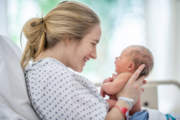 istock Smiling at her new born baby 1365709650