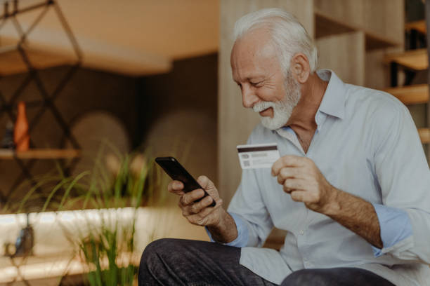 istock Senior man shopping online 1365711081