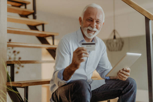 istock Senior man shopping online 1365711475