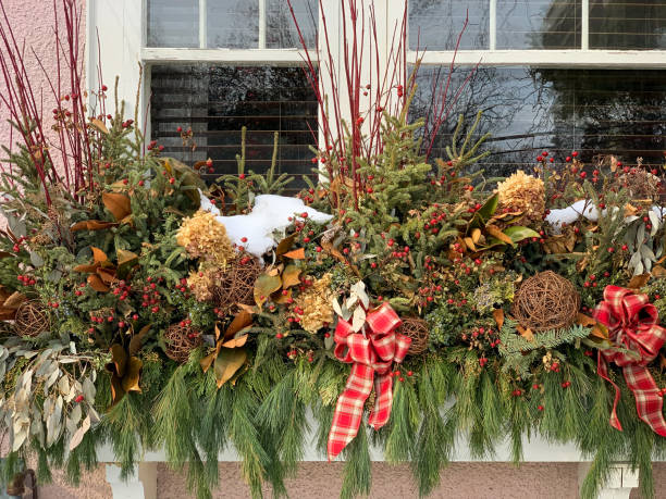 istock Winter window box￼ decorated with pine cones and greens. 1365713815