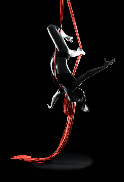 istock Young woman gymnast with red gymnastic aerial silks 1365729708