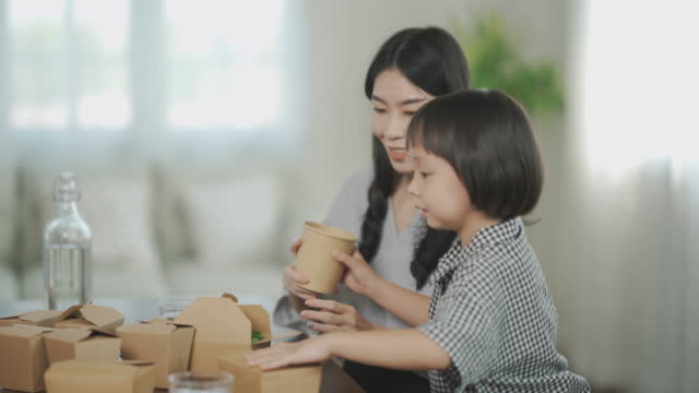 Asian young family enjoying take out food