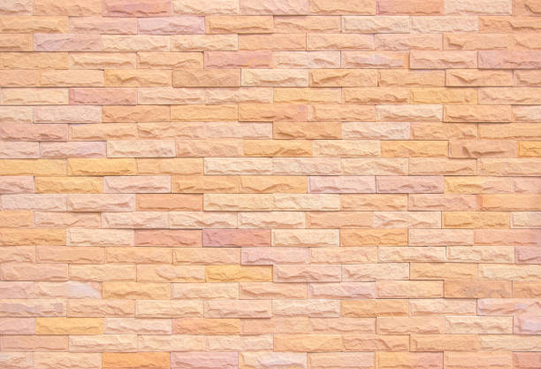 Orange and white brick wall texture background. Brickwork and stonework flooring interior rock old pattern clean concrete grid uneven bricks office design. Background old vintage brick wall backdrop