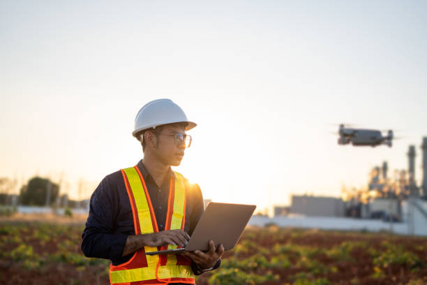 istock Engineers are using laptop control drones to perform aerial inspections at work. Useful technology in work 1365732663