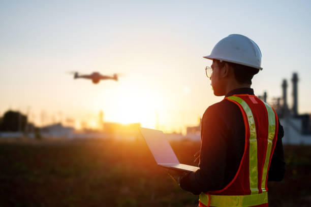 Engineers are using laptop control drones to perform aerial inspections at work. Useful technology in work stock photo