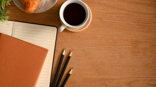 istock A study table with notebooks, pencils and copy space on wooden background. 1365735493