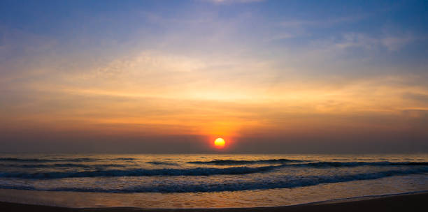 istock Panoramic Sunset over sea in the sky at coastline 1365741056