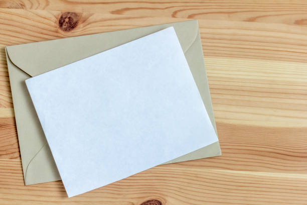 istock Blank greeting or invitation card mockup on wooden background. 1365741300