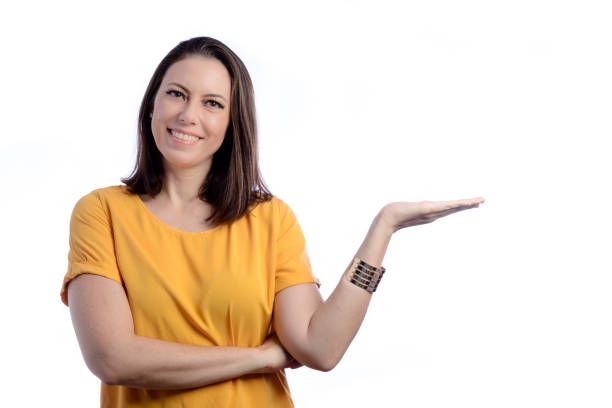 istock Young woman looking at camera smiling and showing product 1365742135