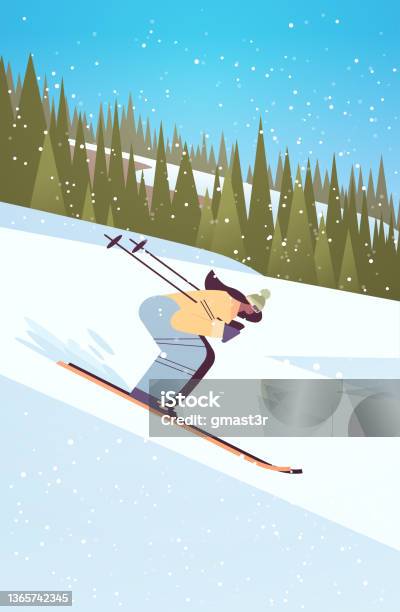 skier man sliding down fresh powder snowy mountain fir tree forest