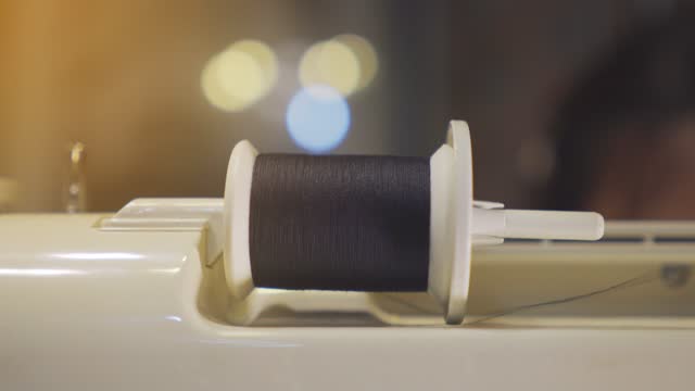 The movement of the sewing thread spool.