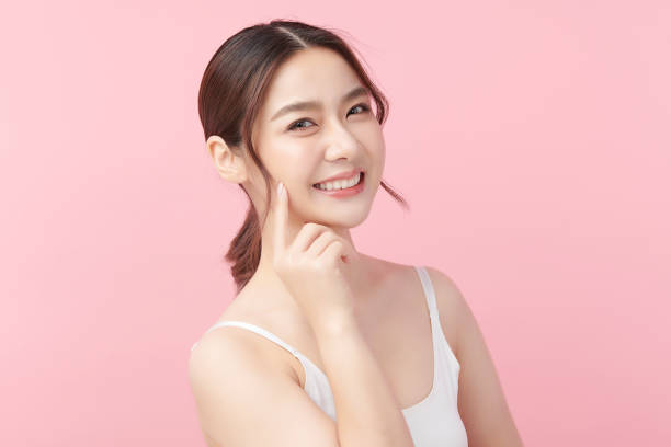 beautiful young asian woman with clean fresh skin on pink background, face care, facial treatment, cosmetology, beauty and spa, asian women portrait. - lifting device imagens e fotografias de stock