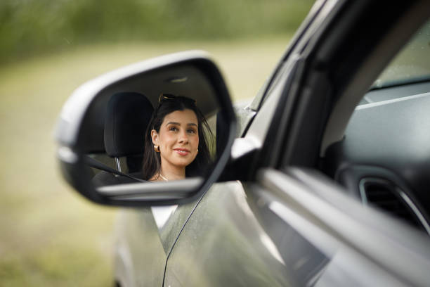 istock Woman inside a car rearview mirror 1365751338