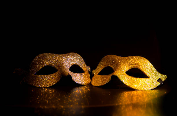 istock two bright carnival masks on black background 1365753613